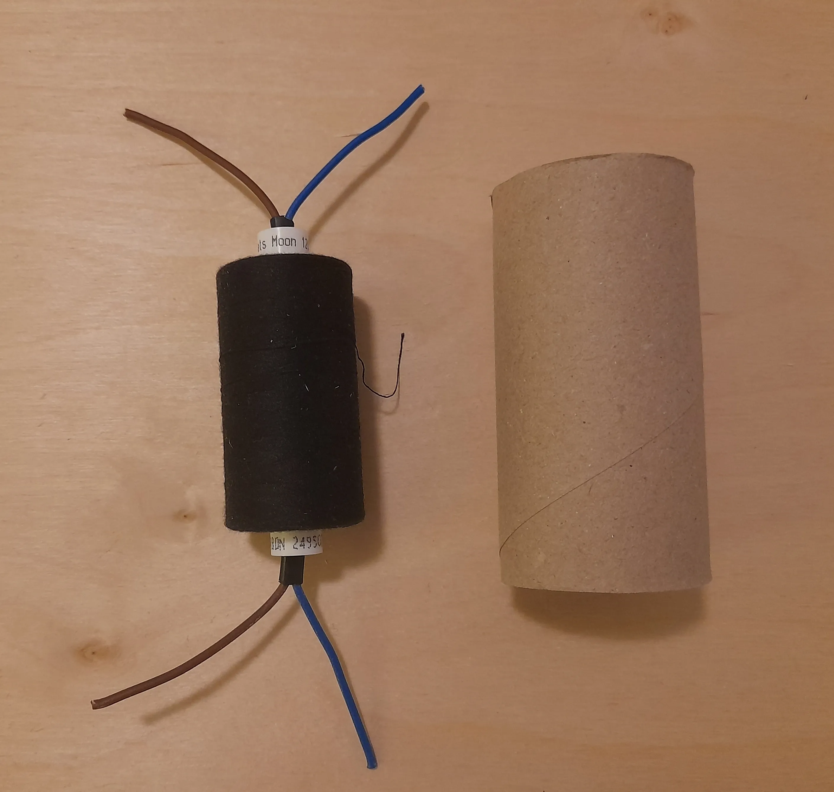 Two strings pushed through the center hole of the spool