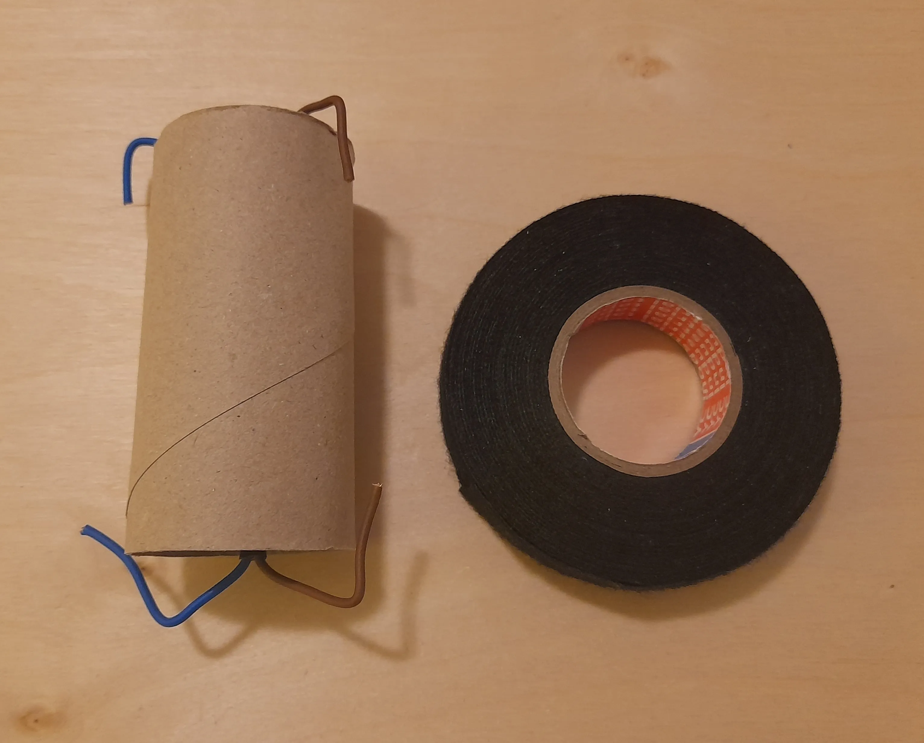 Spool placed inside the toilet paper roll with strings bent outward