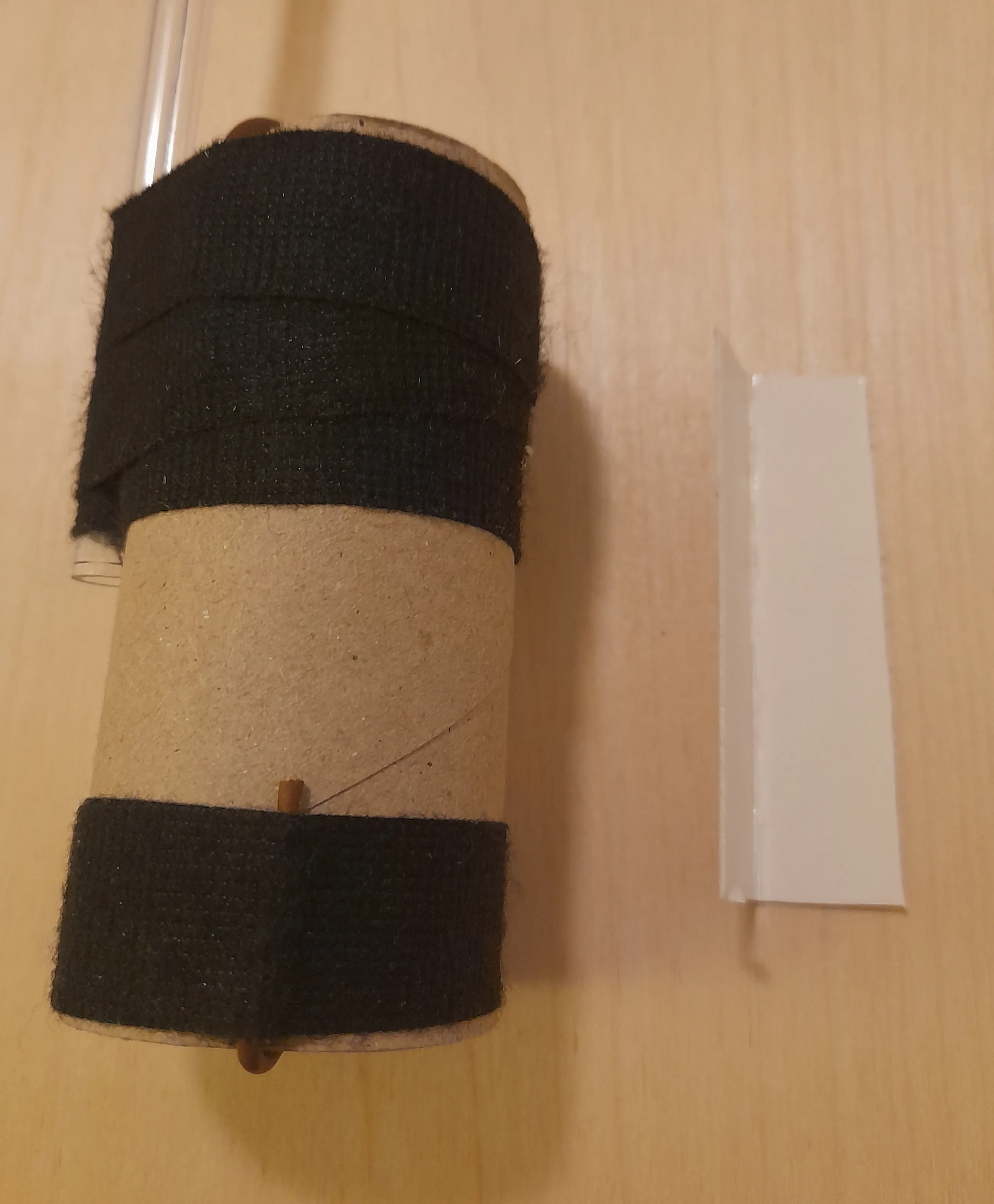 Small piece of cardboard folded into a V shape