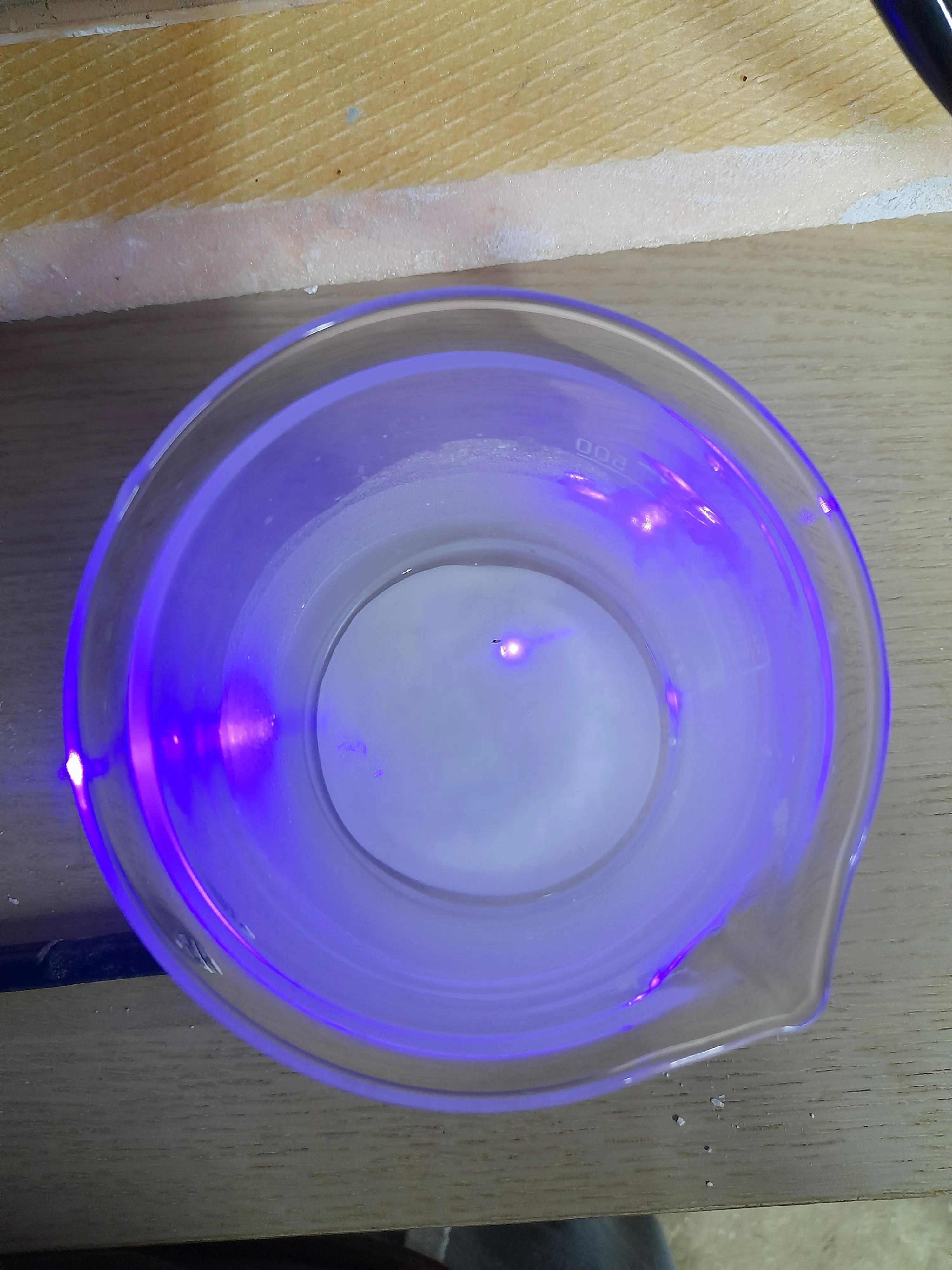 CaWO4 in a beaker excited with near UV